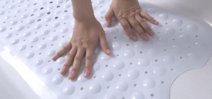 Examining the suction cups of the nonslip bath mat